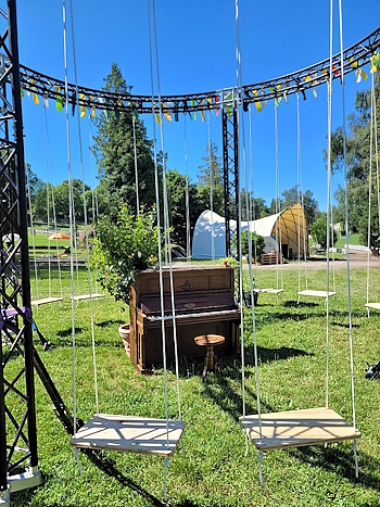 Contact Piano Tuner Bern – old upright piano tuned by Kurt Wieland at a Swisscom event in Bern, placed on the lawn for visitors to play.